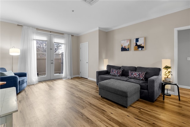 living room featuring ornamental molding, french doors, wood finished floors, and baseboards