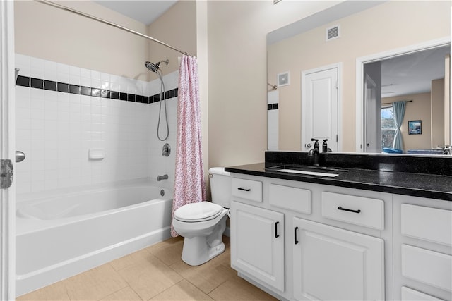 bathroom featuring visible vents, toilet, tile patterned flooring, shower / bath combo with shower curtain, and vanity