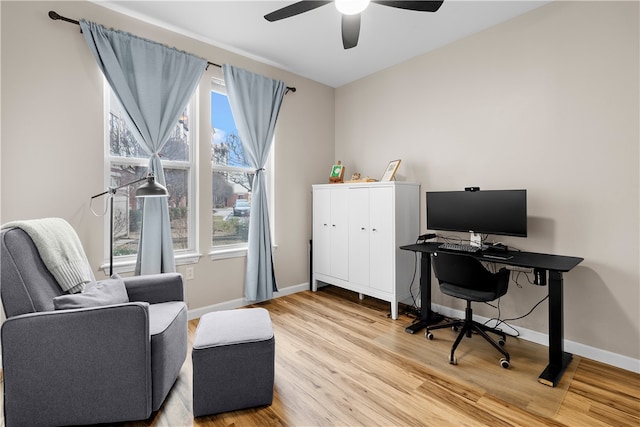 office space featuring ceiling fan, wood finished floors, and baseboards