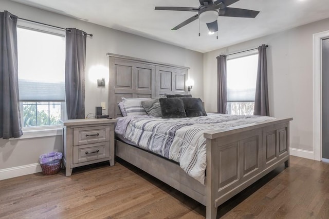 bedroom featuring light wood-style flooring, baseboards, and ceiling fan