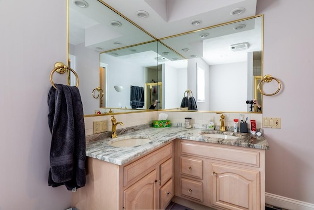 bathroom featuring double vanity, a sink, and decorative backsplash