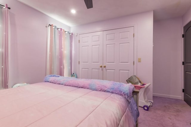 carpeted bedroom with a ceiling fan, baseboards, and a closet