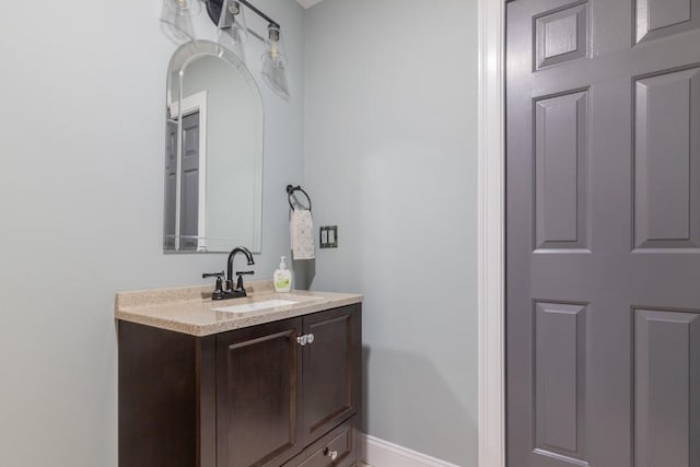 bathroom with vanity and baseboards