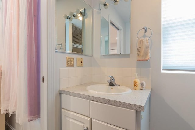 bathroom featuring tasteful backsplash and vanity