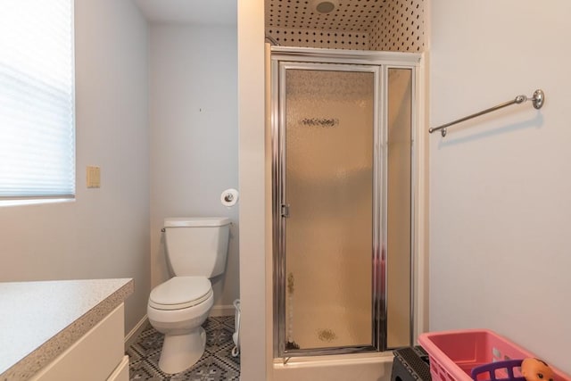 full bath with toilet, a shower stall, vanity, tile patterned flooring, and baseboards