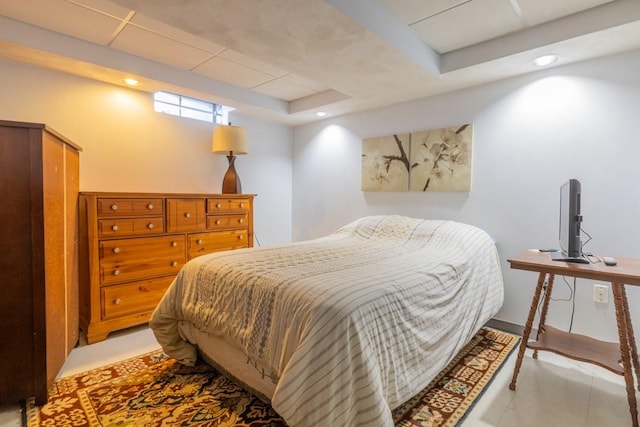 bedroom with a tray ceiling and recessed lighting