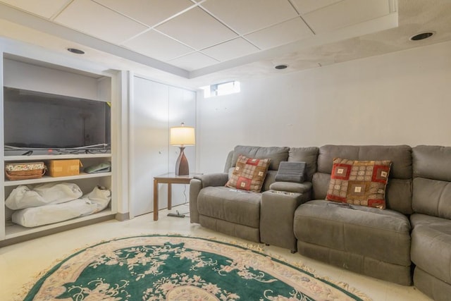 living area featuring a paneled ceiling