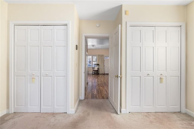 hall with carpet floors and baseboards