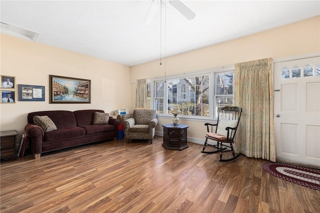 interior space with ceiling fan, baseboards, and wood finished floors