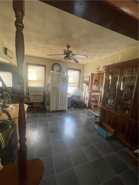 entryway featuring dark tile patterned flooring and a ceiling fan