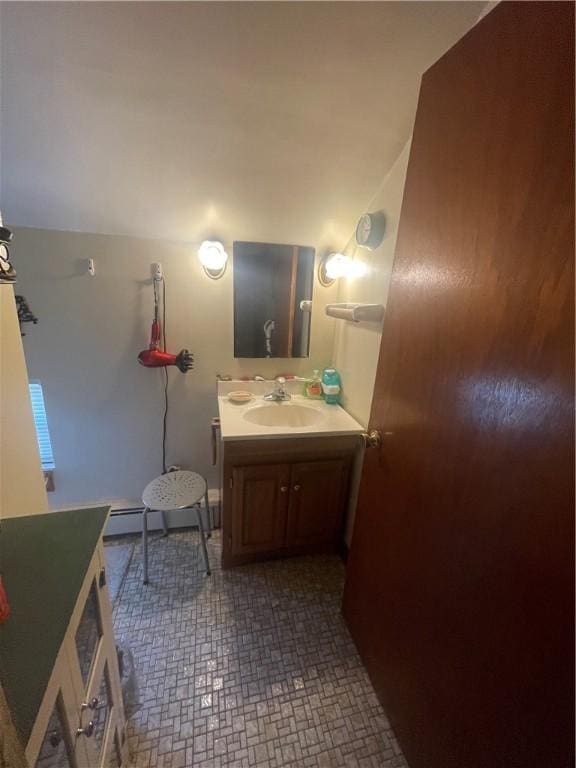 bathroom with baseboard heating and vanity