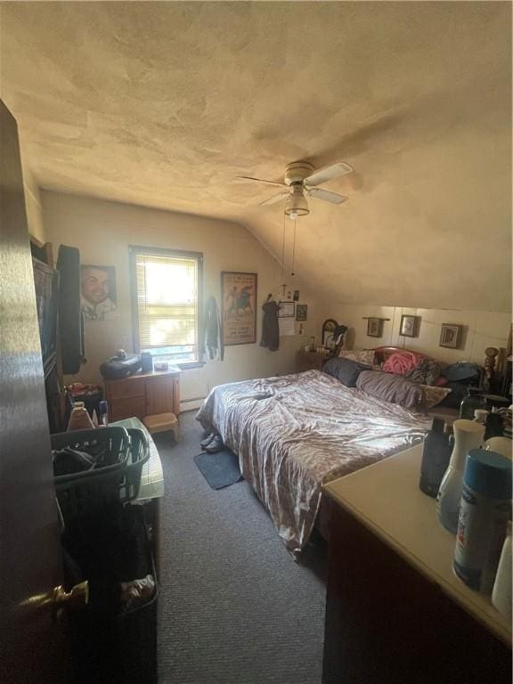 bedroom with carpet floors, lofted ceiling, ceiling fan, and a textured ceiling