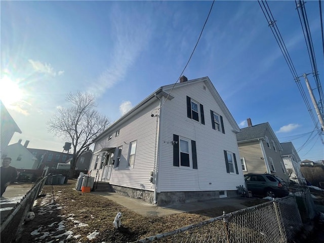 view of property exterior featuring fence