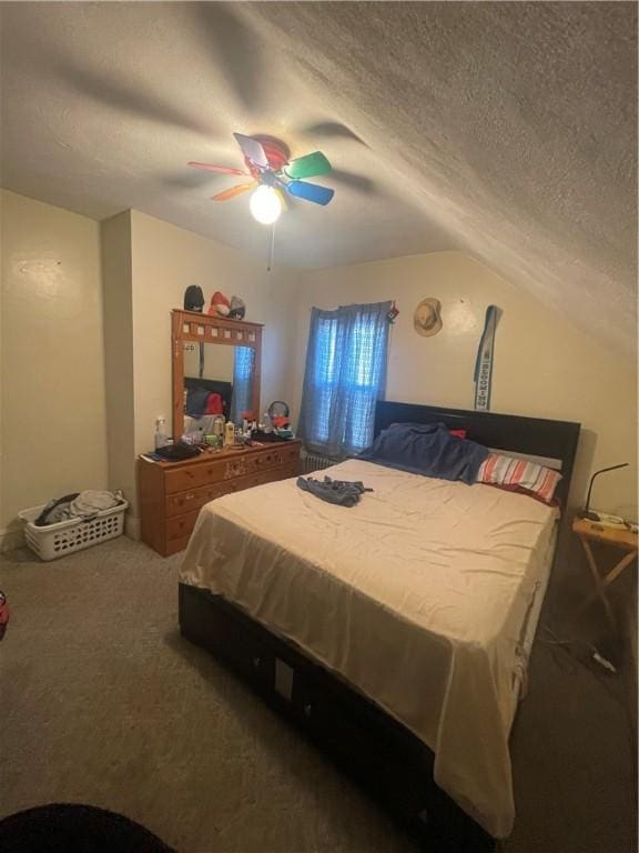 bedroom featuring a ceiling fan, carpet, vaulted ceiling, and a textured ceiling