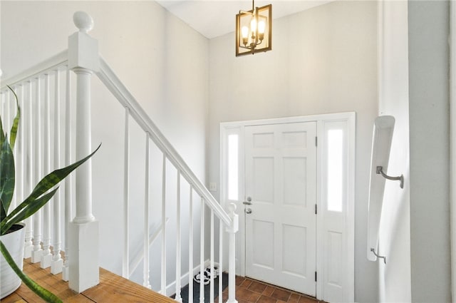 entryway featuring stairway and a towering ceiling