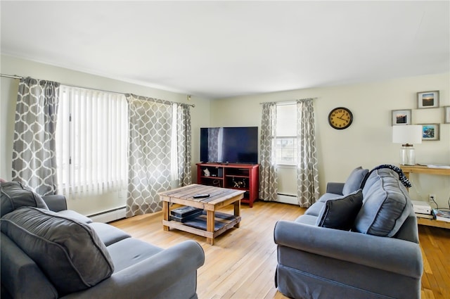 living area with a baseboard radiator and light wood finished floors