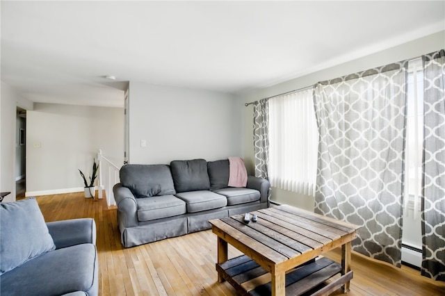 living room with wood-type flooring and baseboards