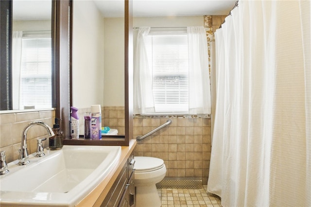 bathroom featuring tile walls, curtained shower, toilet, vanity, and tile patterned flooring