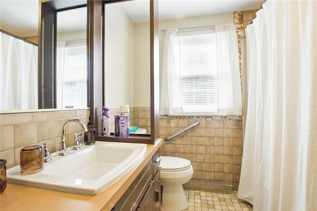 bathroom featuring toilet, tile patterned floors, curtained shower, vanity, and tile walls