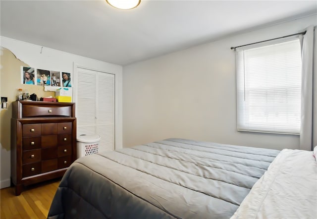 bedroom featuring a closet and wood finished floors