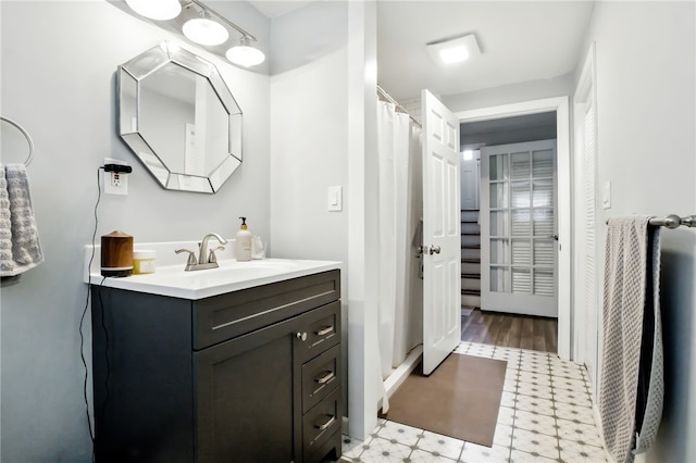 bathroom with a shower stall, vanity, and tile patterned floors