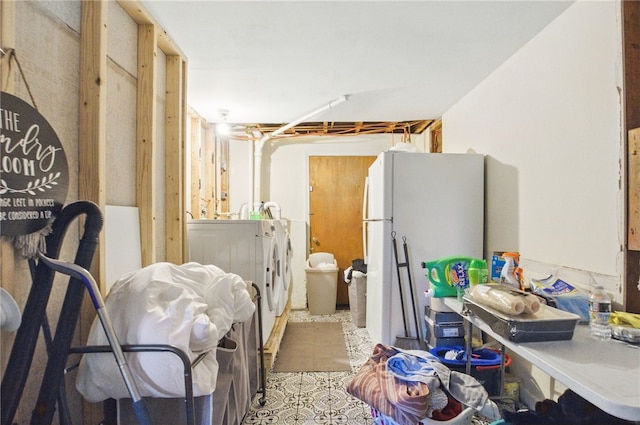 kitchen featuring freestanding refrigerator and independent washer and dryer