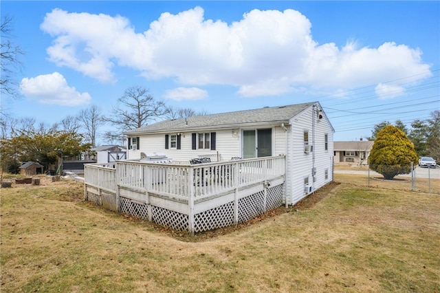 back of house featuring a deck and a yard