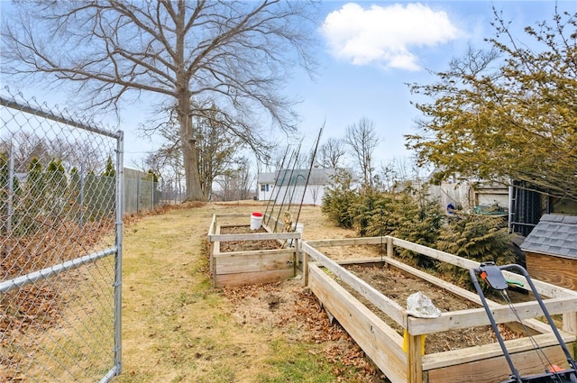 view of yard featuring fence and a garden