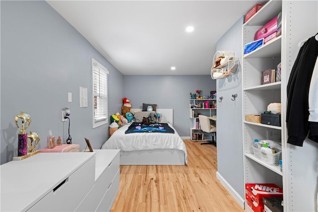 bedroom with light wood-type flooring, baseboards, and recessed lighting