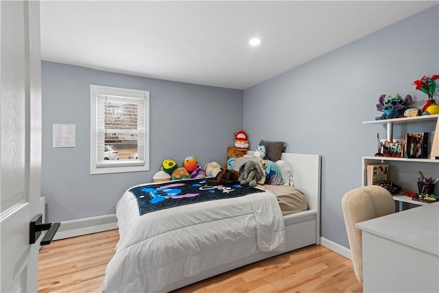 bedroom with light wood-style floors, baseboards, and recessed lighting