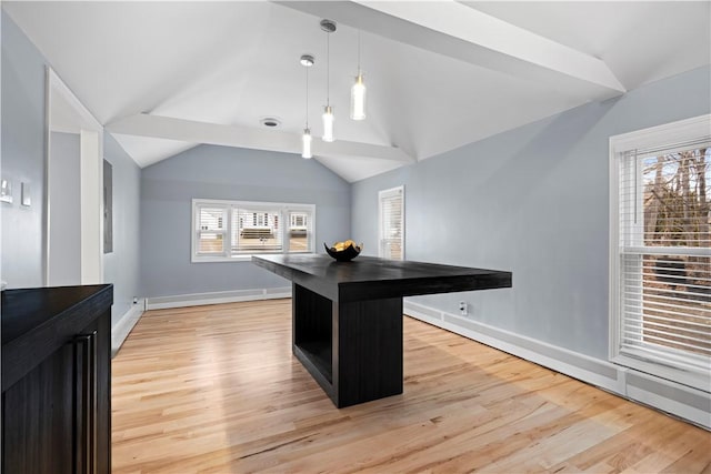 kitchen with lofted ceiling, dark countertops, light wood-style flooring, and baseboards