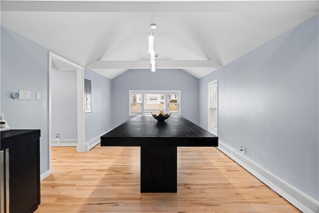 dining area featuring baseboards, light wood-style flooring, and lofted ceiling with beams