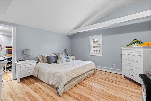 bedroom featuring lofted ceiling and light wood-style flooring