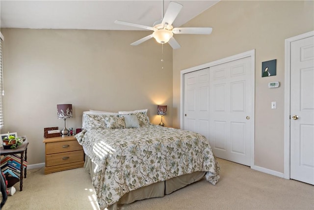 bedroom with a ceiling fan, baseboards, a closet, and light colored carpet