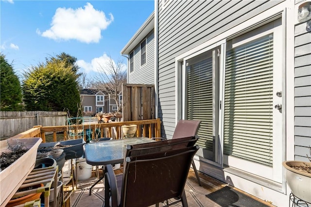 deck featuring outdoor dining area and fence