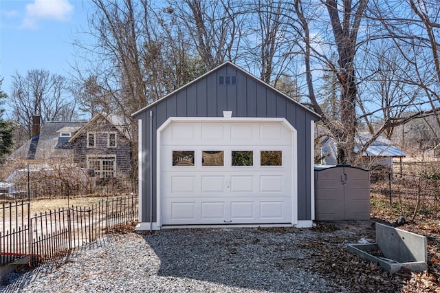 detached garage with driveway and fence