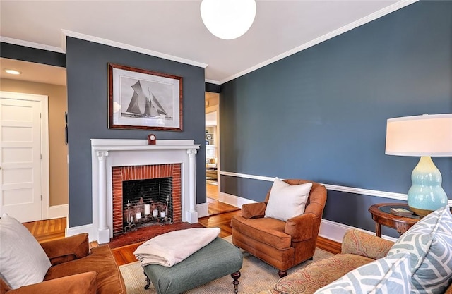 living room featuring ornamental molding, a brick fireplace, wood finished floors, and baseboards