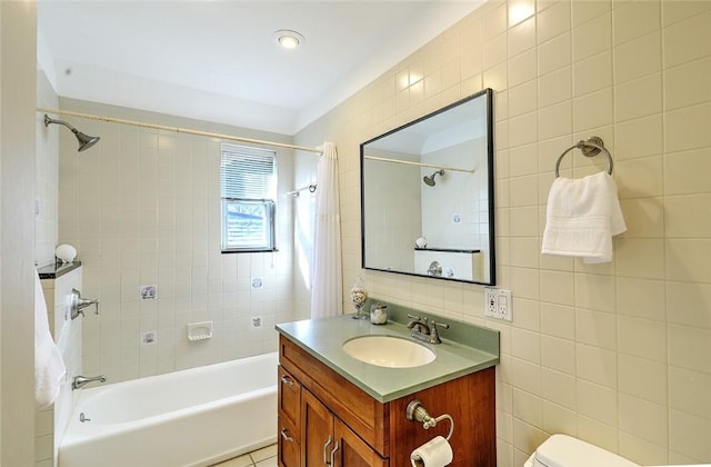 full bath featuring toilet, shower / bathtub combination with curtain, tile walls, and vanity