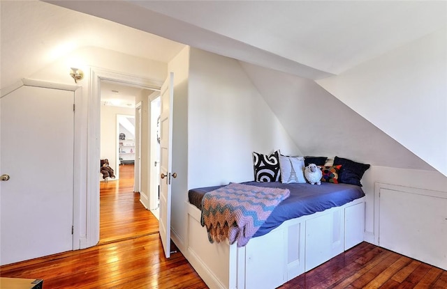 bedroom featuring hardwood / wood-style flooring and vaulted ceiling