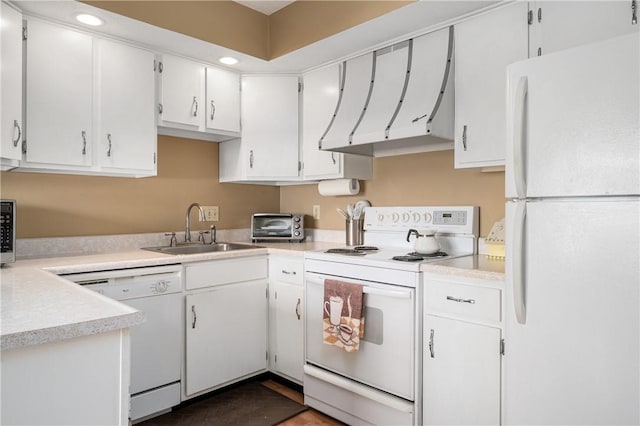 kitchen with light countertops, white appliances, a sink, and white cabinetry