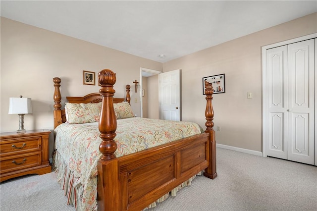 bedroom featuring a closet, light carpet, and baseboards