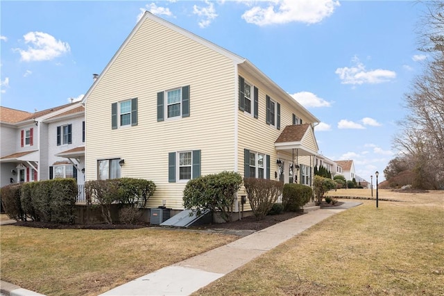 view of home's exterior with a yard and central AC unit