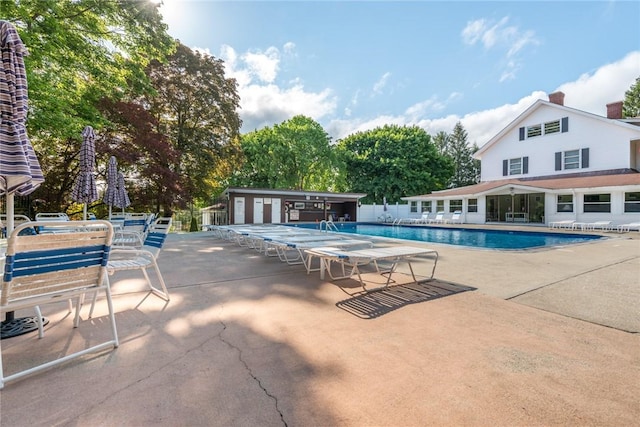 pool featuring a patio area and fence