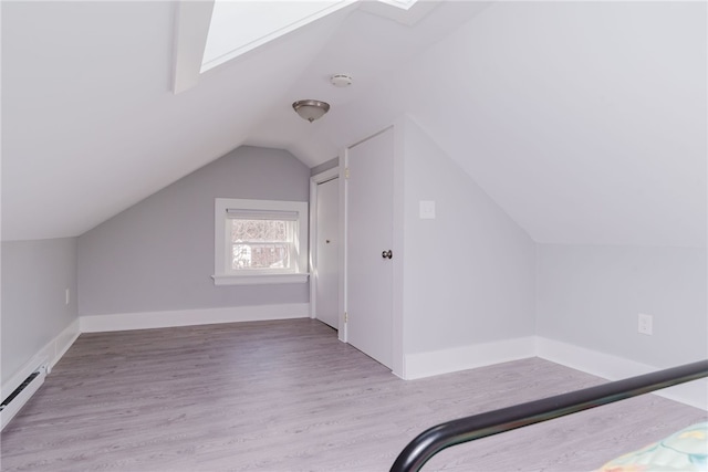 bonus room featuring lofted ceiling, a baseboard radiator, baseboards, and wood finished floors