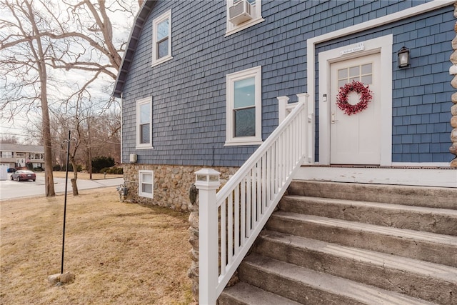 doorway to property with a yard