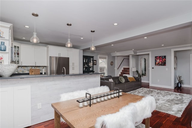 kitchen with recessed lighting, dark wood-style flooring, white cabinets, and stainless steel refrigerator