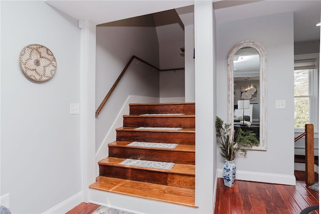 stairway with baseboards and wood finished floors