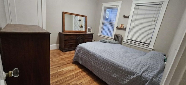 bedroom with baseboards and wood finished floors