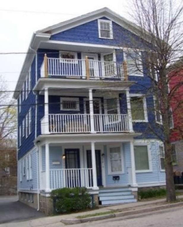 view of front of home featuring covered porch and a balcony