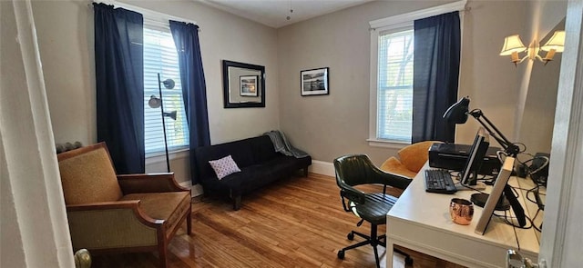 home office with baseboards, wood finished floors, and a wealth of natural light